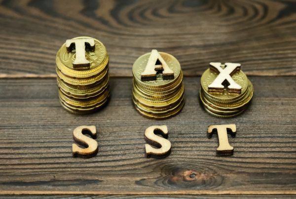 high angle view coins with tax sst text table