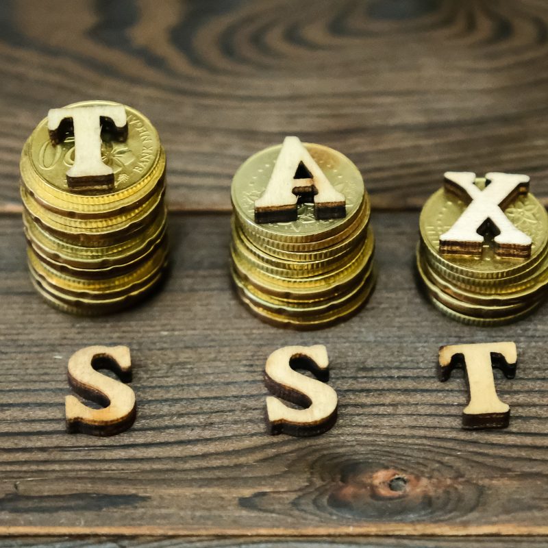 high angle view coins with tax sst text table